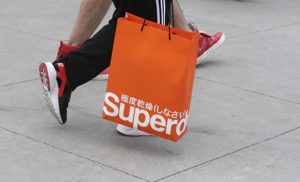 CENTRAL VALLEY, NY - AUGUST 26: A person carries a bag from the Superdry store at the Woodbury Common Premium Outlets shopping mall on August 26, 2018 in Central Valley, New York. (Photo by Gary Hershorn/Getty Images)