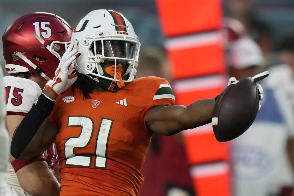 FILE -Miami running back Henry Parrish Jr. celebrates after running for yardage during the first half of an NCAA college football game against Miami (Ohio), Friday, Sept. 1, 2023, in Miami Gardens, Fla. Oregon State running back Damien Martinez, Miami running back Henry Parrish and Pitt defensive end Jayon Hayes entered the transfer portal as the 14-day spring window opened for college football players.(AP Photo/Wilfredo Lee, File)