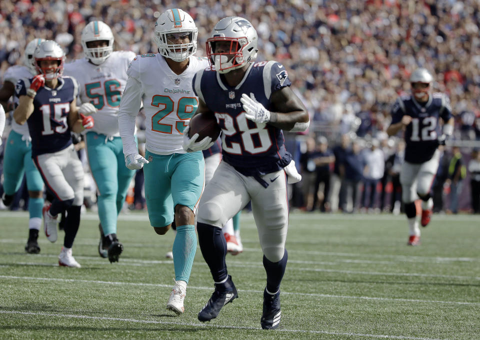 New England Patriots running back James White (28) runs past Miami Dolphins defensive back Minkah Fitzpatrick (29) for a touchdown during the first half of an NFL football game, Sunday, Sept. 30, 2018, in Foxborough, Mass. (AP Photo/Steven Senne)