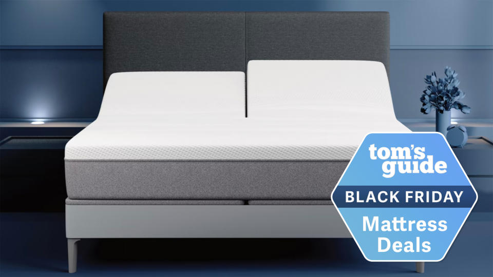  Sleep Number i8 Smart Bed on a grey bedframe in a blue bedroom with a Black Friday mattress deals badge overlaid. 