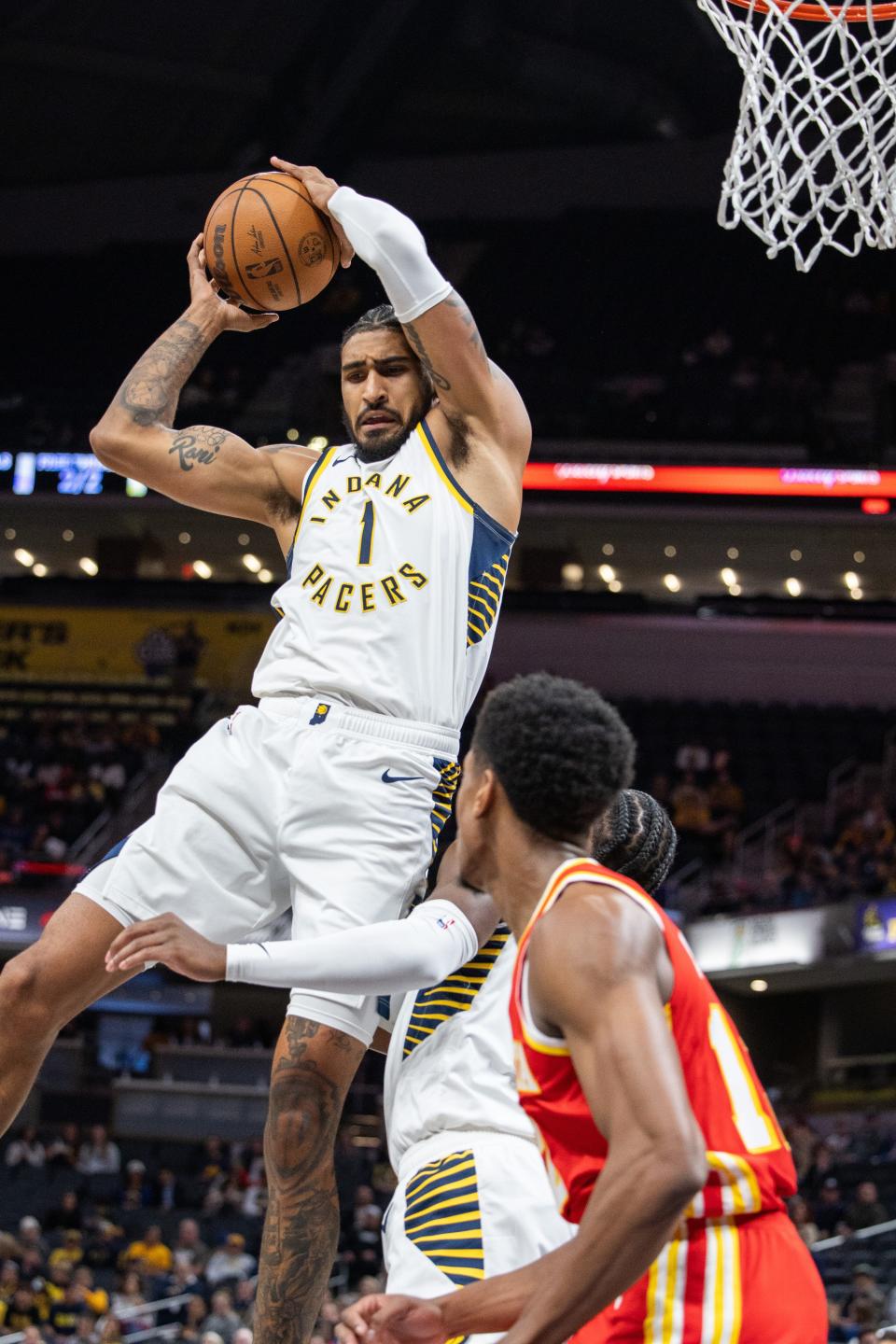 Oct 16, 2023; Indianapolis, Indiana, USA; Indiana Pacers forward Obi Toppin (1) rebounds the ball in the first quarter against the Atlanta Hawks at Gainbridge Fieldhouse. Mandatory Credit: Trevor Ruszkowski-USA TODAY Sports