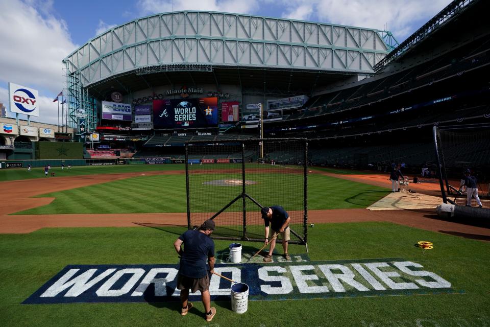 Stadium workers prepare the World Series field on Oct. 25, 2021, in Houston.