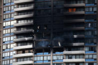 <p>The charred exterior of the Marco Polo Building is pictured after a fire broke out on the upper floors in Honolulu, Hawaii, on July 14, 2017. (Photo: Kent Nishimura/AFP/Getty Images) </p>