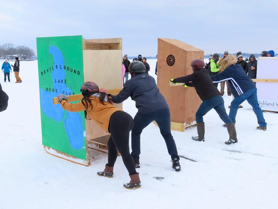 Participants are seen competing in the outhouse race on ice-covered Devils Lake during a previous Devils and Round Lake Men's Club Tip-Up Festival. This year's outhouse races are scheduled for 4 p.m. Saturday, Feb. 4, outside the Manitou Beach Marina, either on the ice or in the marina's parking lot.