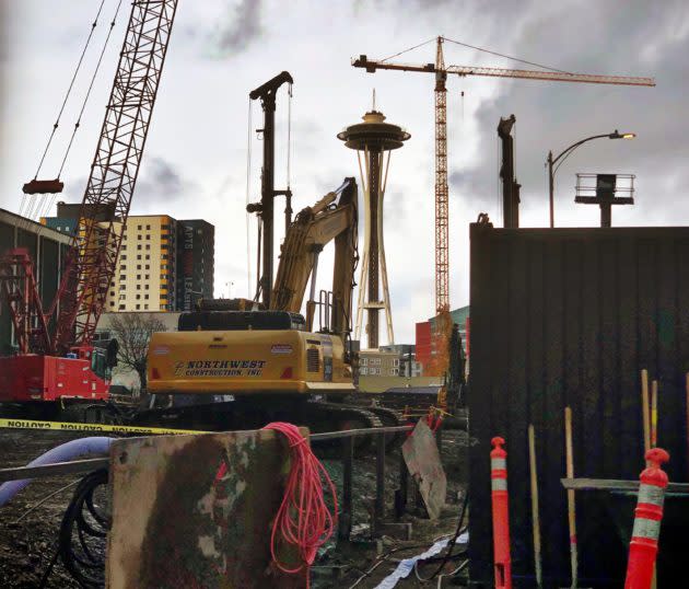 The Space Needle stands out amid cranes and construction materials near Amazon’s towers in Seattle. (GeekWire Photo / Kurt Schlosser)