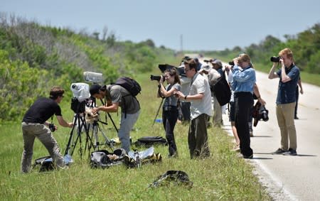 Photographers set up remote cameras for the launch of a SpaceX Falcon Heavy rocket, carrying the U.S. Air Force's Space Test Program-2 mission, at the Kennedy Space Center in Cape Canaveral