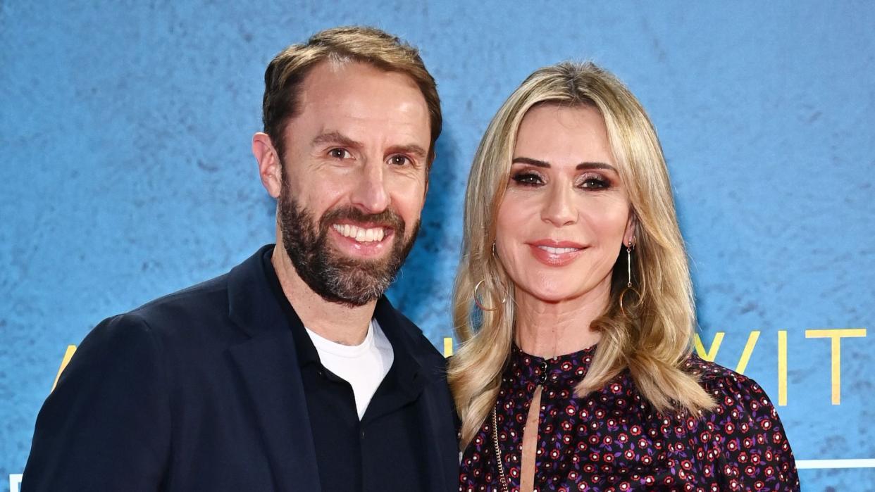 Gareth Southgate and Alison Bird in a blue suit jacket and patterned dress