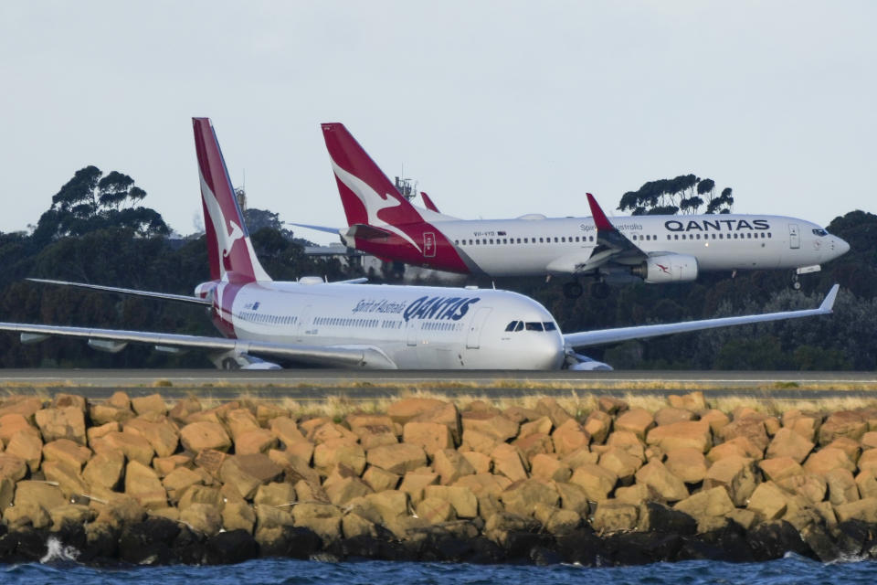 FILE - Qantas passenger jets cross as they taxi at Sydney Airport in Sydney, Australia, Monday, Sept. 5, 2022. Australian national carrier Qantas posted an underlying pre-tax half-year profit of 1.43 billion Australian dollars ($978 million) on Thursday, Feb. 23, 2023, in the airline's first return to profit since the coronavirus pandemic started three years ago. (AP Photo/Mark Baker/File)