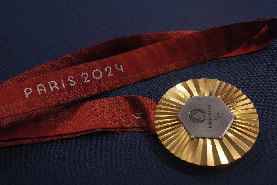 The Paris 2024 Paralympic gold medal is presented to the press, in Paris, Thursday, Feb. 1, 2024. A hexagonal, polished piece of iron taken from the Eiffel Tower is being embedded in each gold, silver and bronze medal that will be hung around athletes' necks at the July 26-Aug. 11 Paris Games and Paralympics that follow. (AP Photo/Thibault Camus)