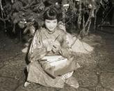 <p>At a Christmas celebration for Hollywood stars at the Christy Hotel in 1932, Anna May Wong opens up a Christmas gift under the tree.</p>