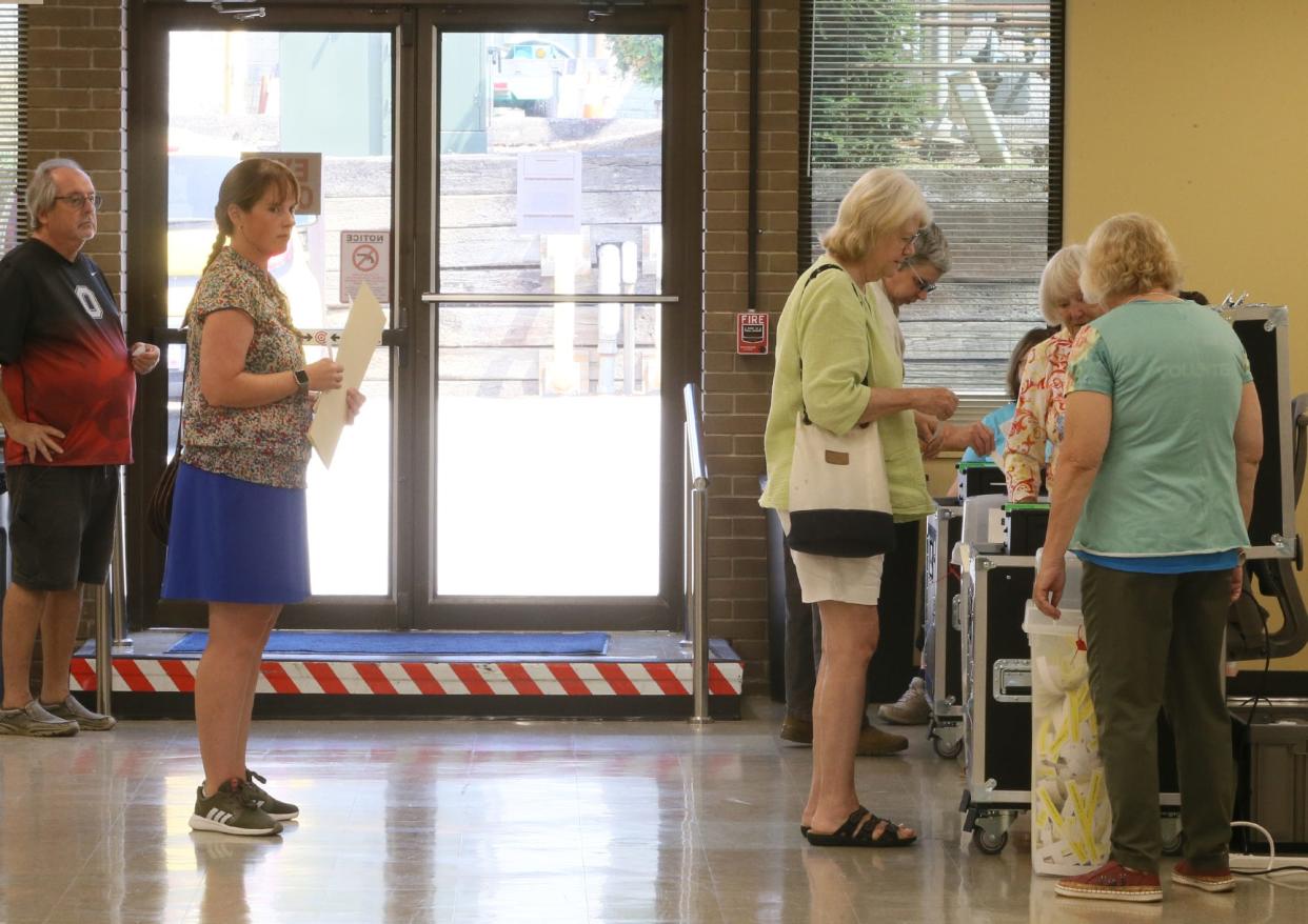 Voters wait to cast their ballot on Issue 1 in the Summit County Board of Election Early Voting Center in Akron.