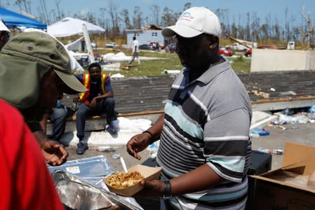 A volunteer delivers food during an evacuation operation after Hurricane Dorian hit the Abaco Islands in Treasure Cay