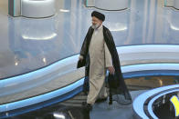 In this picture made available by Young Journalists Club, YJC, presidential candidate for June 18, elections Ebrahim Raisi leaves at the conclusion of a part of the final debate of the candidates, at a state-run TV studio in Tehran, Iran, Saturday, June 12, 2021. Iran's seven presidential candidates offered starkly different views Saturday in the country's final debate, with hard-liners describing those seeking ties with the West as "infiltrators" and the race's sole moderate warning a hard-line government would only bring more sanctions for the Islamic Republic. (Morteza Fakhri Nezhad/ Young Journalists Club, YJC via AP)