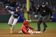 Los Angeles Angels' Anthony Rendon steals second base as Tampa Bay Rays second baseman Curtis Mead, left, misses the tag during the third inning of a baseball game in Anaheim, Calif., Tuesday, April 9, 2024. (AP Photo/Alex Gallardo)