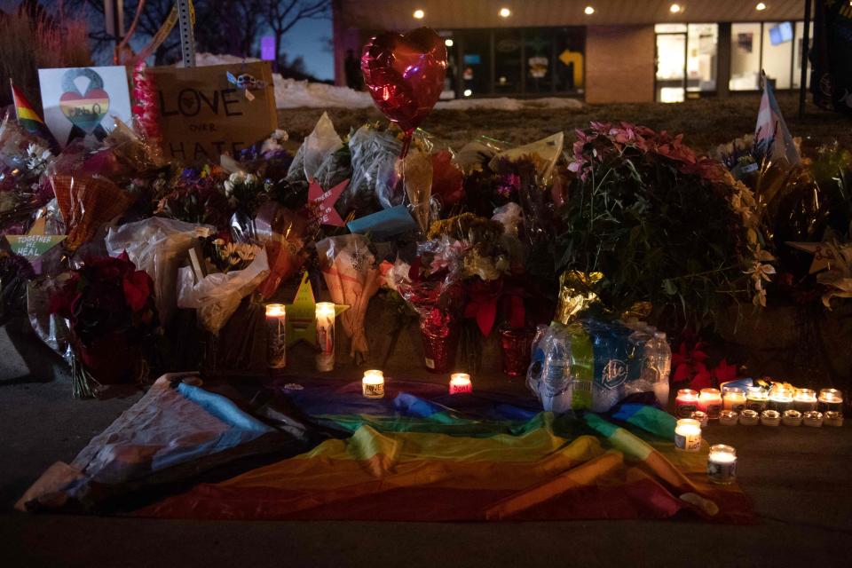 Flower bouquets, candles, and other items from a memorial near the LGBTQ nightclub, Club Q, in Colorado Springs, Colorado.