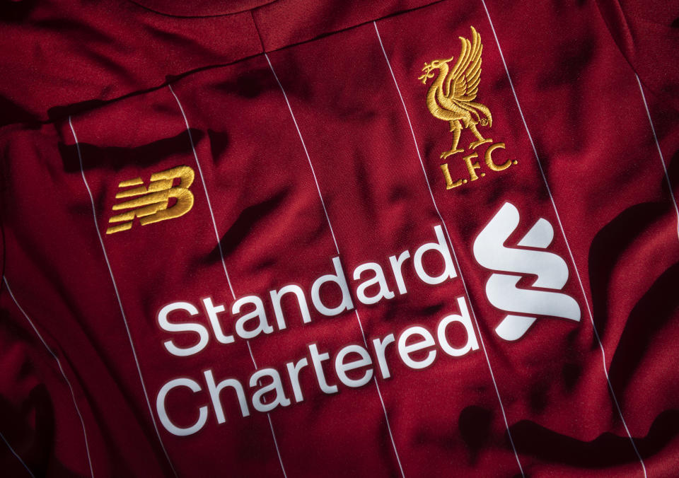 MANCHESTER, ENGLAND - MAY 05: The Liverpool club crest on the first team home shirt displayed with the sponsors Standard Chartered and New Balance on May 5, 2020 in Manchester, England (Photo by Visionhaus)