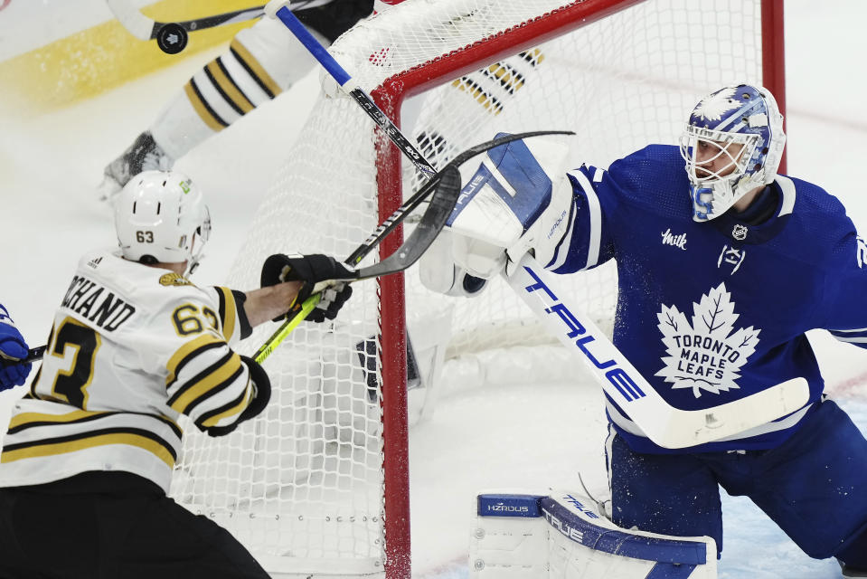 Toronto Maple Leafs goaltender Ilya Samsonov, right, makes a save as Boston Bruins' Brad Marchand (63) looks for a rebound during second-period action in Game 4 of an NHL hockey Stanley Cup first-round playoff series in Toronto, Saturday, April 27, 2024. (Nathan Denette/The Canadian Press via AP)