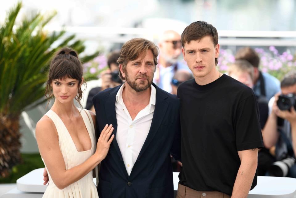 Actress Charlbi Dean Kriek, director Ruben Ostlund and actor Harris Dickinson attend the photocall for "Triangle Of Sadness" during the 75th annual Cannes film festival at Palais des Festivals on May 22, 2022 in Cannes, France.