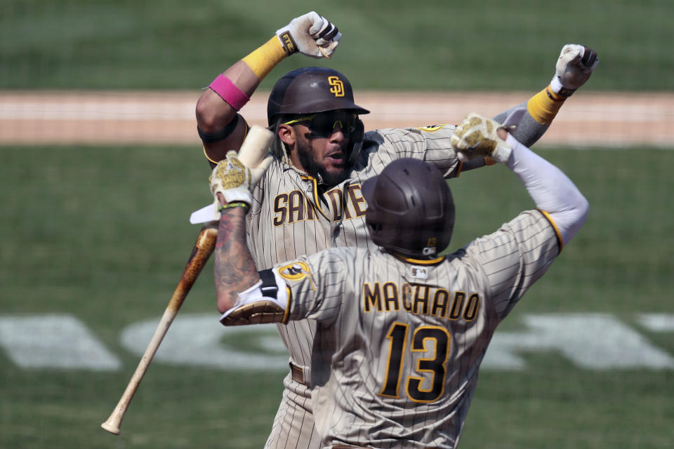 San Diego Padres' Fernando Tatis Jr celebrates after hitting a solo home run against the Oakland Athletics with teammate Manny Machado during the seventh inning of a baseball game in Oakland, Calif., Sunday, Sept. 6, 2020. (AP Photo/Jed Jacobsohn)