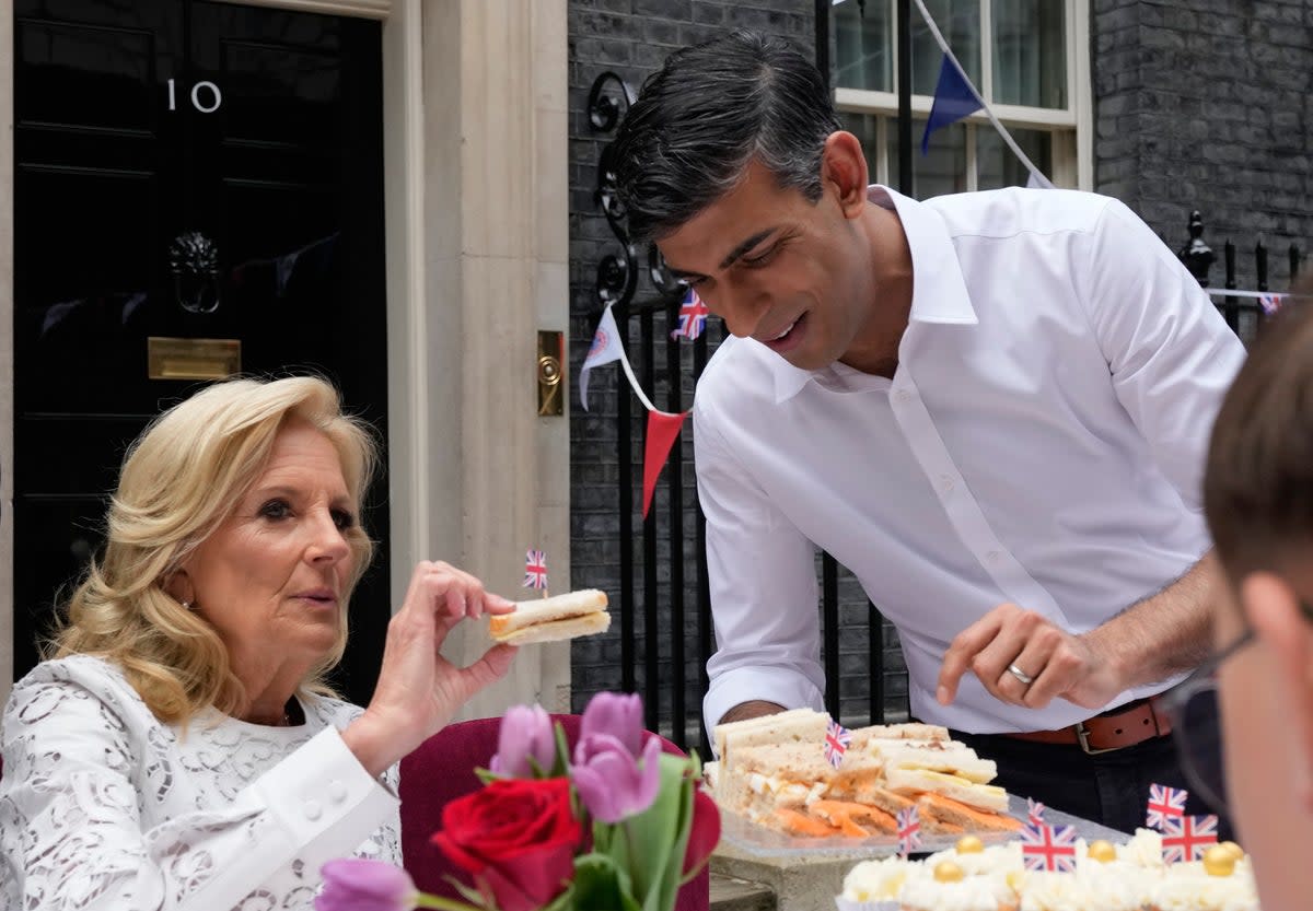 Rishi Sunak holds plate of sandwiches as Jill Biden takes one (Getty Images)
