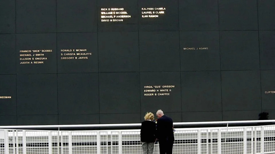 The wife of Columbia Commander Rick D. Husband, Evelyn Husband (left), and then NASA Associate Administrator Bill Readdy place a wreath October 28, 2003, at the Astronaut Memorial in Kennedy Space Center during a dedication adding the Columbia crew (top). - Bruce Weaver/AFP/Getty Images