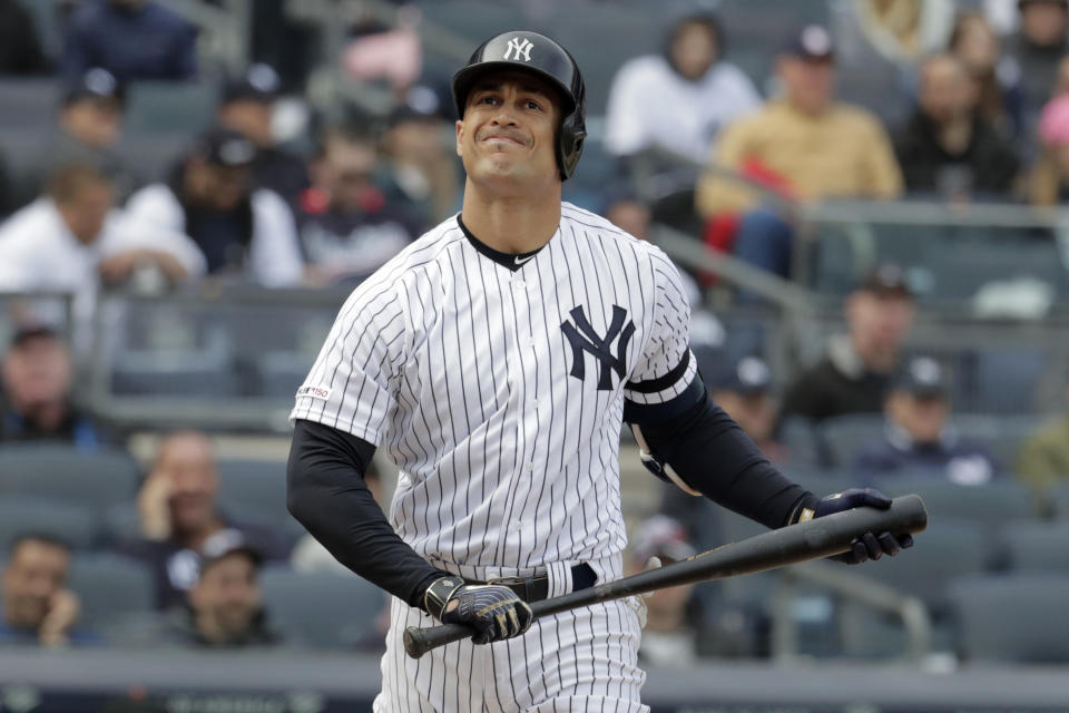 New York Yankees' Giancarlo Stanton reacts after striking out to Baltimore Orioles relief pitcher Paul Fry during the eighth inning of an opening day baseball game at Yankee Stadium, Thursday, March 28, 2019, in New York. The Yankees won 7-2. (AP Photo/Julio Cortez)