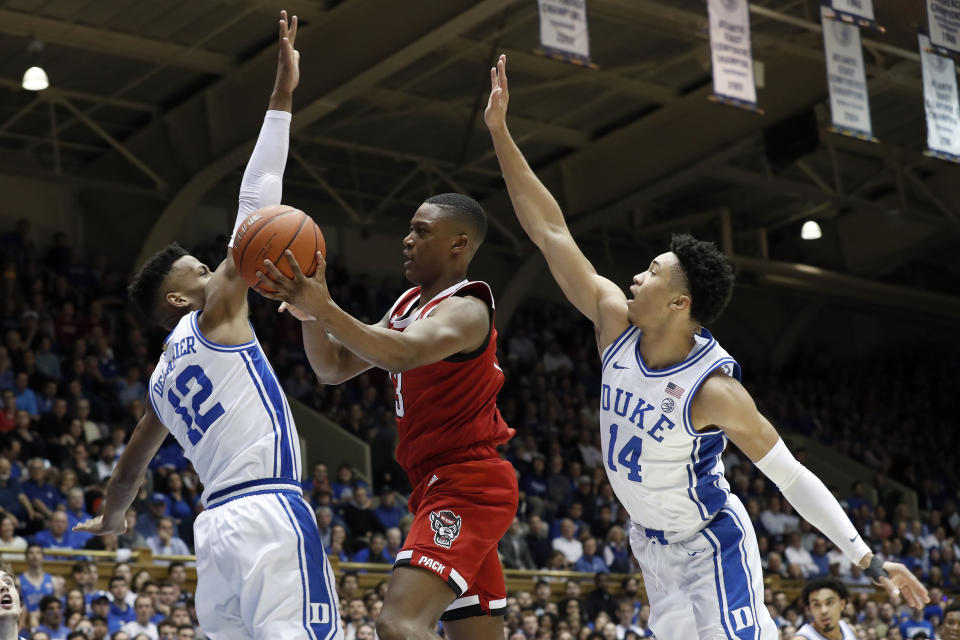 North Carolina State guard C.J. Bryce drives between Duke forward Javin DeLaurier (12) and guard Jordan Goldwire (14) during the first half of an NCAA college basketball game in Durham, N.C., Monday, March 2, 2020. (AP Photo/Gerry Broome)