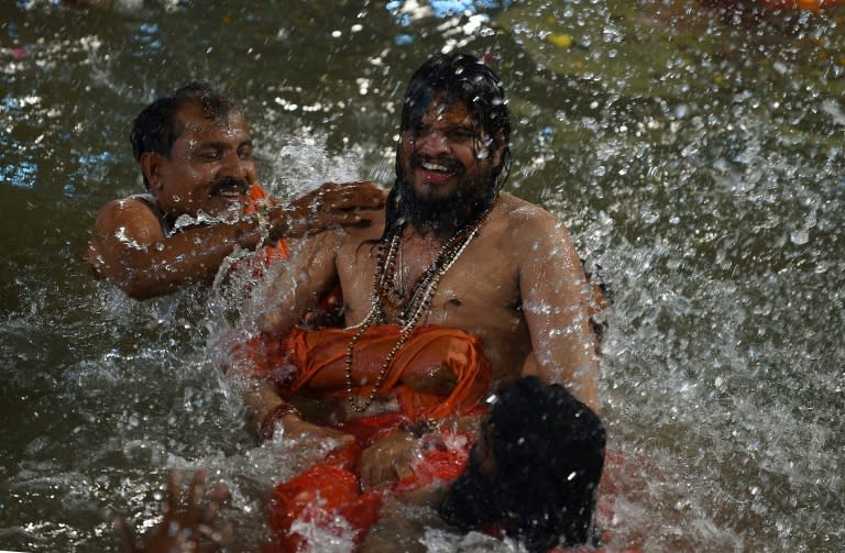 Indian Hindu holy men take the first holy dip at the Kumbh Mela in Trimbakeshwar near Nashik on August 29, 2015