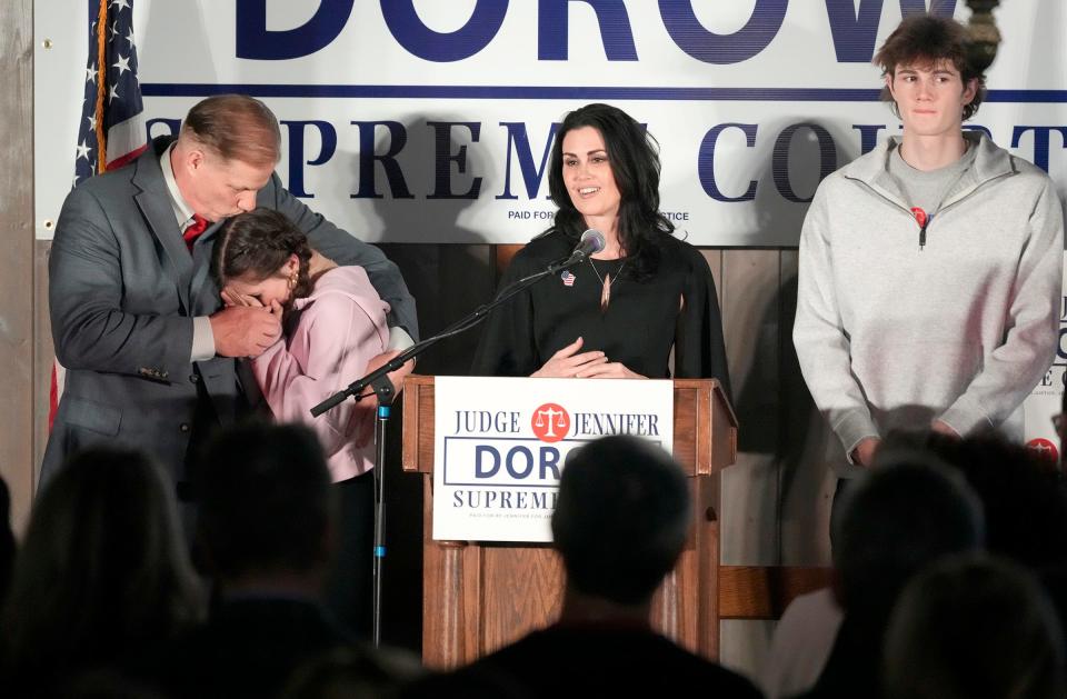 Waukesha County Judge and Wisconsin Supreme Court nominee, Jennifer Dorow concedes the election as her husband Brian Dorow consoles their daughter Kiki next to her son Jonny (far right) at her primary election night watch party at the Golden Mast restaurant on Okauchee Lake in Okauchee on Tuesday.