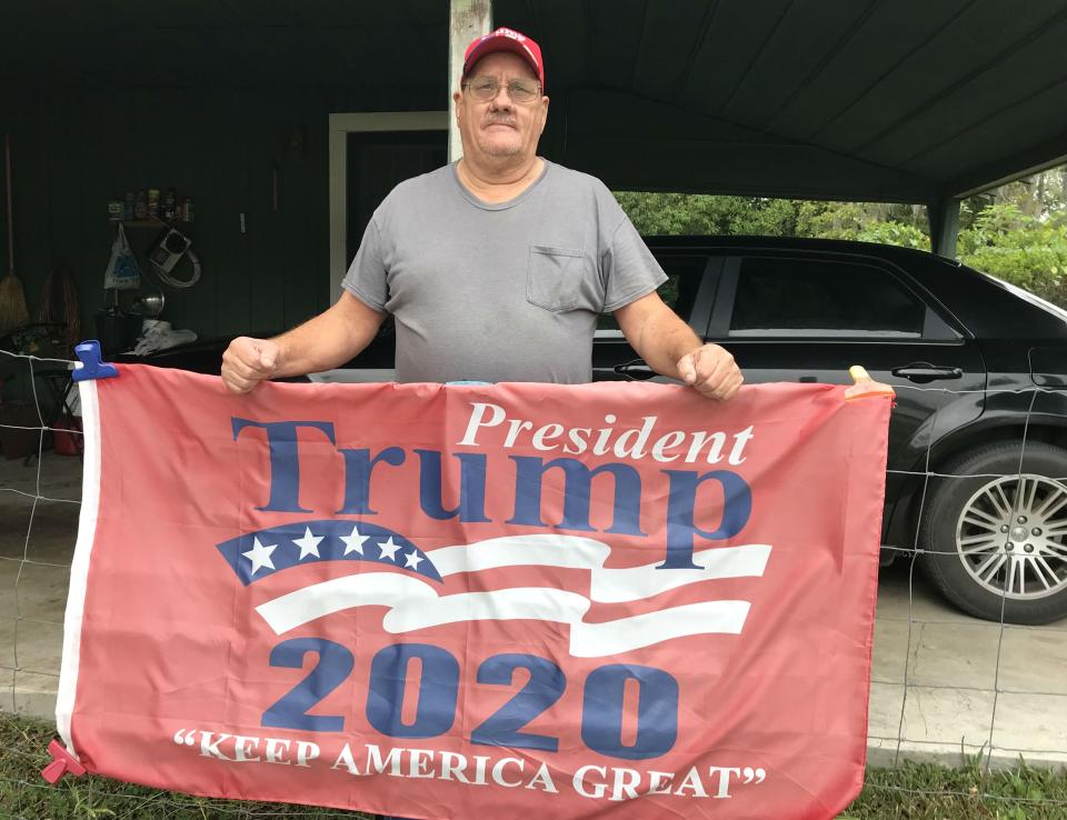 Larry Crews built his own pro-Trump sign - but wears a mask when he leaves home (Andrew Buncombe)