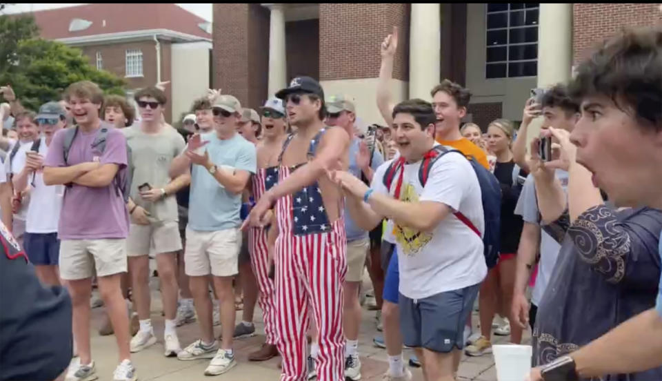 In this photo taken from video provided by Stacey J. Spiehler, hecklers shout at a pro-Palestinian protester at the University of Mississippi, Thursday, May 2, 2024, in Oxford, Miss. The hecklers vastly outnumbered pro-Palestine demonstrators and video shot by a student journalist showed one white heckler making monkey gestures and noises at a Black woman who was supporting pro-Palestinian protesters. (Stacey J. Spiehler via AP)