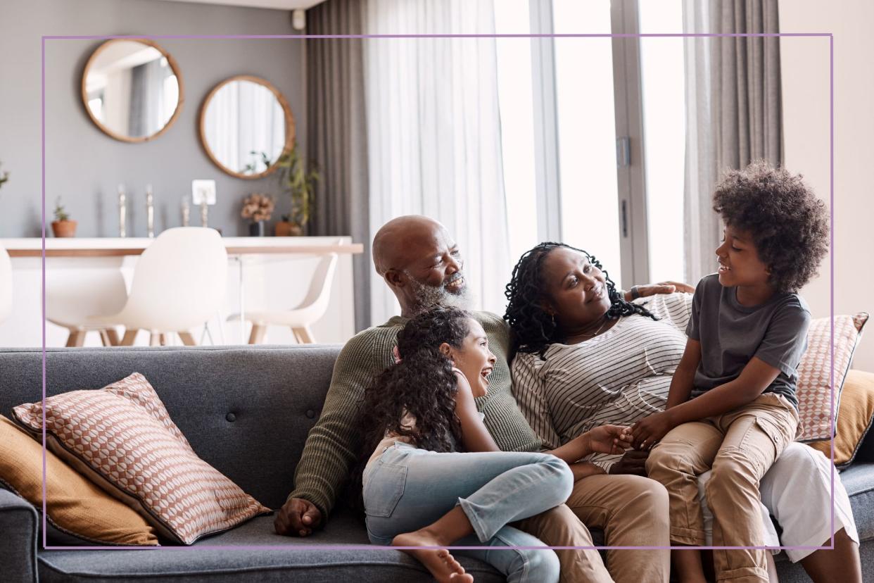  Man and woman with kids on a sofa. 