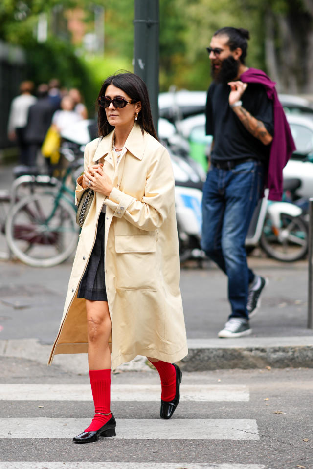 A guest wears a Vuitton brown monogram pyjama outfit, outside