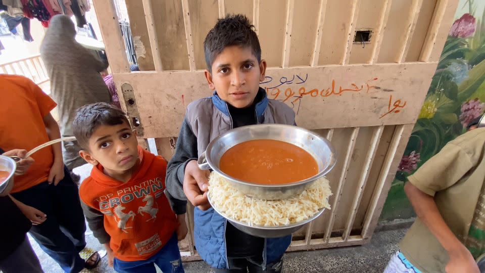 Zaki Sobeh (right), a young Palestinian boy, pictured at a shelter in Deir al-Balah, on Wednesday, told CNN he had not received a hot meal in over a month. - CNN