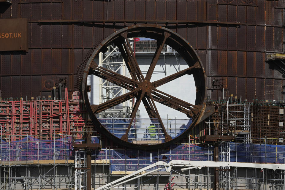 An employee works at the site of a nuclear reactor at Hinkley Point C nuclear power station in Somerset, England, Tuesday, Oct. 11, 2022. Sites like the Hinkley Point C nuclear power plant have become integral to the U.K. government’s “net zero” by 2050 strategy. (AP Photo/Kin Cheung)