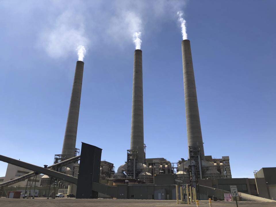 This Aug. 20, 2019, image shows a trio of concrete stacks at the Navajo Generating Station near Page, Ariz. The power plant will close before the year ends, upending the lives of hundreds of mostly Native American workers who mined coal, loaded it and played a part in producing electricity that powered the American Southwest. (AP Photo/Susan Montoya Bryan)