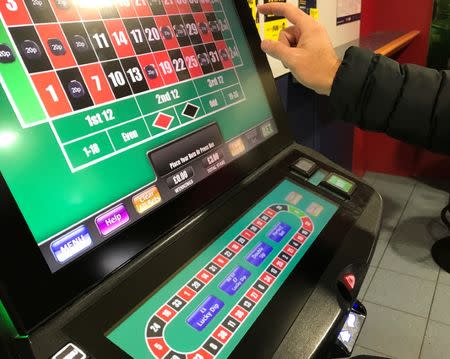 A man gambles on a fixed odds betting terminal inside a Bookmakers in Manchester, Britain, October 31, 2017. REUTERS/Phil Noble/File Photo