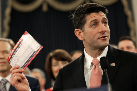 Speaker of the House Paul Ryan (R-WI) holds a sample tax form as he unveils legislation to overhaul the tax code on Capitol Hill in Washington, U.S., November 2, 2017. REUTERS/Joshua Roberts
