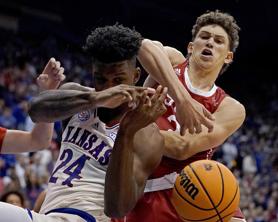 Kansas forward K.J. Adams Jr. (24) battles for a rebound with Southern Utah guard Drake Allen (3) during the first half of an NCAA college basketball game Friday, Nov. 18, 2022, in Lawrence, Kan. (AP Photo/Charlie Riedel)