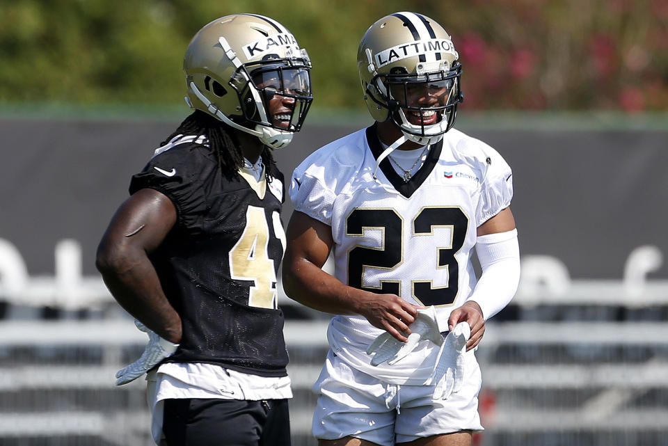 FILE - New Orleans Saints running back Alvin Kamara (41) and cornerback Marshon Lattimore (23) talk during NFL football practice in Metairie, La., Thursday, July 26, 2018. Both Lattimore and Kamara skipped voluntary practices this week. (AP Photo/Jonathan Bachman, File)