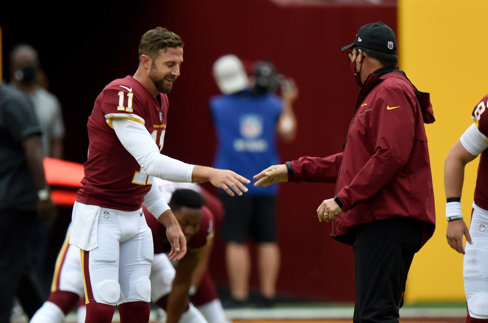 Alex Smith reaches out to shake Ron Rivera's hand.