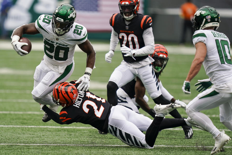 Cincinnati Bengals' Mike Hilton (21) tackles New York Jets' Breece Hall (20) during the first half of an NFL football game Sunday, Sept. 25, 2022, in East Rutherford, N.J. (AP Photo/Seth Wenig)