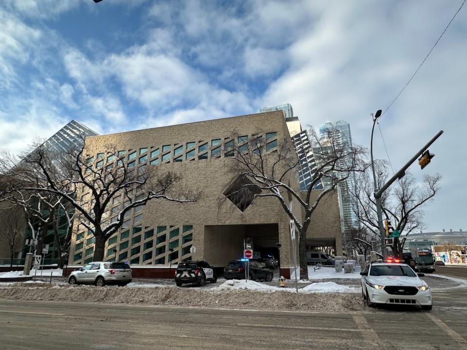 Police vehicles outside Edmonton city hall on Tuesday after a weapons complaint prompted an evacuation of the building.