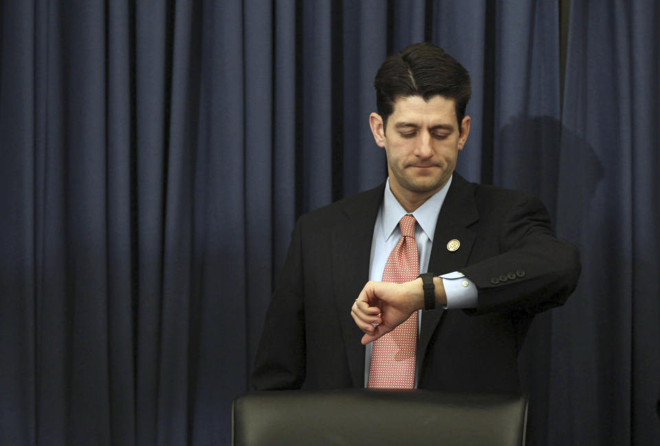 U.S. House Budget Committee Chairman Paul Ryan (R-WI) checks his watch as Director of the White House's Office of Management and Budget, Jacob Lew arrives late to testify at a House Budget Committee hearing on U.S. President Barack Obama's 2012 budget on Capitol Hill in Washington, February 15, 2011. REUTERS/Jason Reed