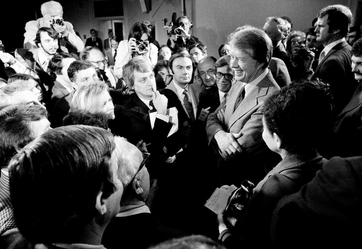 President Jimmy Carter, right, surrounded by journalists after announcing he was lifting the travel ban on Cuba, Vietnam, North Korea and Cambodia, March 9, 1977. <a href="https://newsroom.ap.org/detail/CubaUSKeyEvents/d7db7ad8fbf04e3cb1b9ca6d4989c1a9/photo?Query=(persons.person_featured:(Jimmy%20AND%20Carter))%20AND%20%20(jimmy%20carter)%20&mediaType=photo&sortBy=arrivaldatetime:desc&dateRange=&totalCount=1351&currentItemNo=31" rel="nofollow noopener" target="_blank" data-ylk="slk:AP Photo/file;elm:context_link;itc:0;sec:content-canvas" class="link ">AP Photo/file</a>