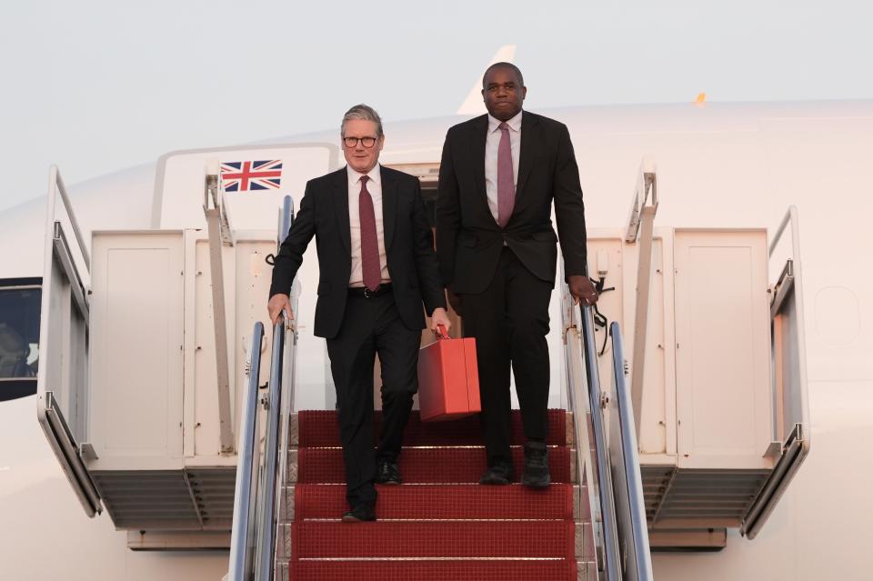 Keir Starmer, left, and Foreign Secretary David Lammy step from their aircraft as they arrive at Joint Base Andrews, Md., ahead of talks with U.S. President Joe Biden (AP)