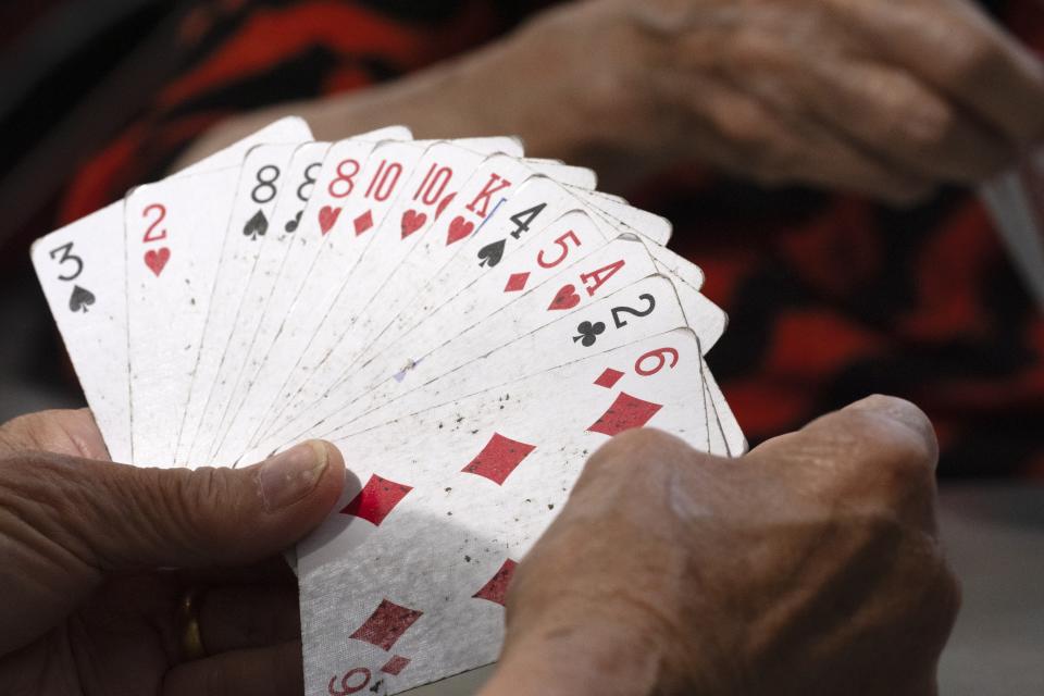 Women play cards in a public park near a remembrance ceremony for Vincent Chin in Chinatown, Sunday, June 23, 2024, in Boston. Over the weekend, vigils were held across the country to honor the memory of Chin, who was killed by two white men in 1982 in Detroit. (AP Photo/Michael Dwyer)