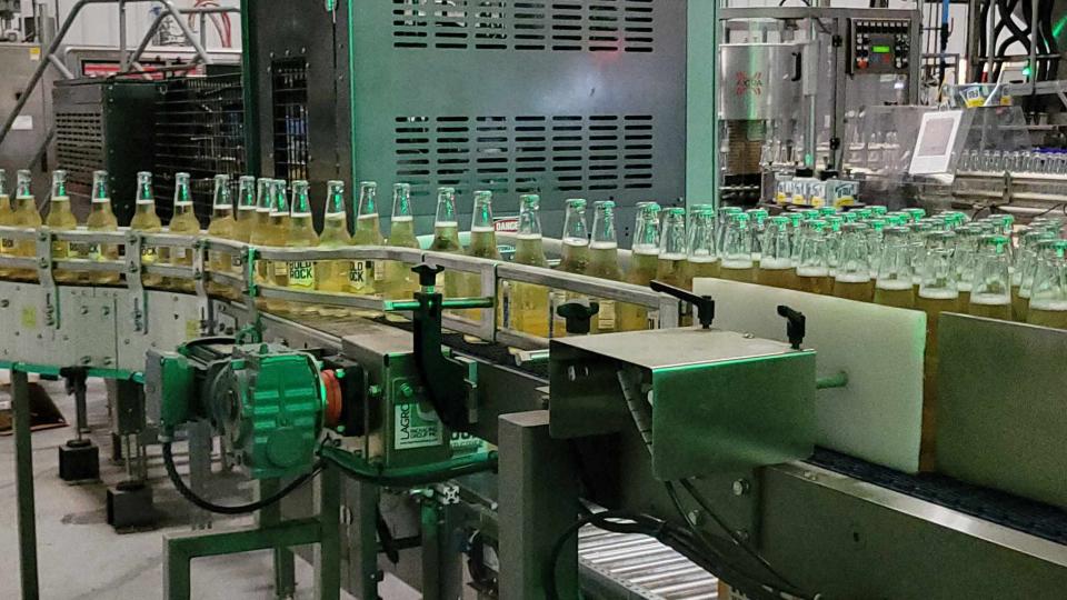Bottles of Bold Rock cider go through the production line on July 11 at Bold Rock Mills River.
