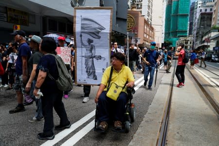 People carry placards at a protest in Hong Kong