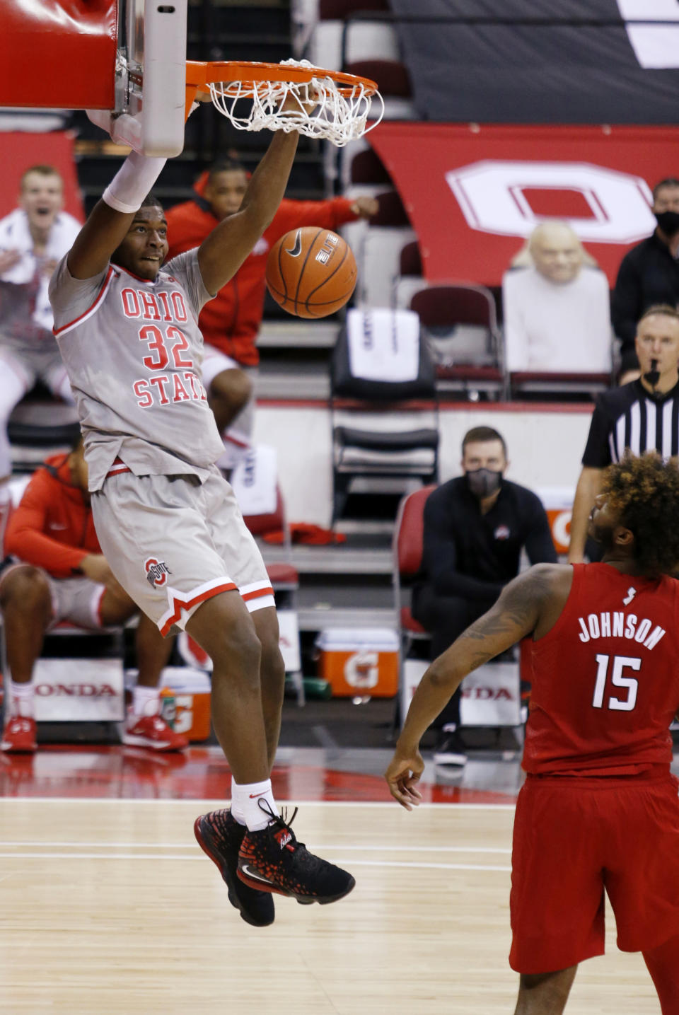 Ohio State forward E.J. Liddell, left, dunks next to Rutgers center Myles Johnson during the second half of an NCAA college basketball game in Columbus, Ohio, Wednesday, Dec. 23, 2020. (AP Photo/Paul Vernon)